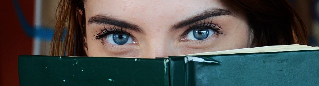 Blue eyes behind a book